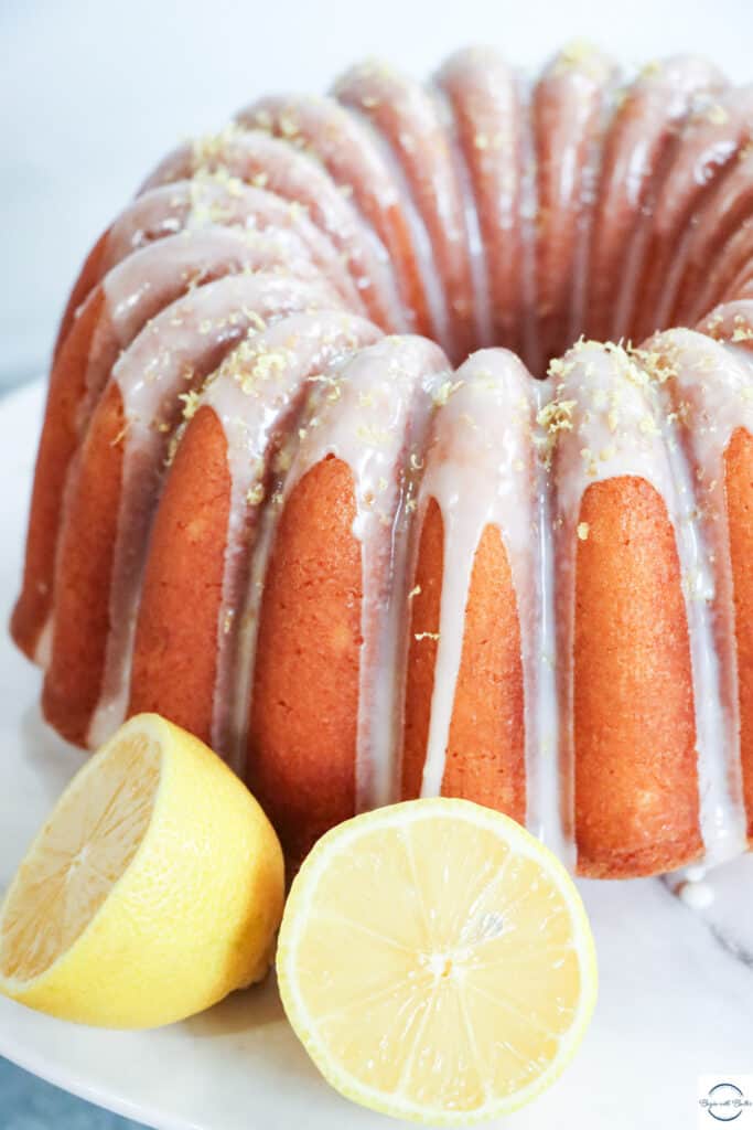 This is a picture of lemon pound cake, surrounded by lemons.