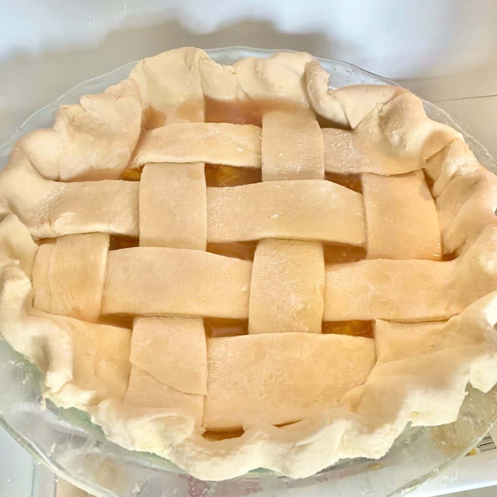 this is a photo of a peach pie before baking.